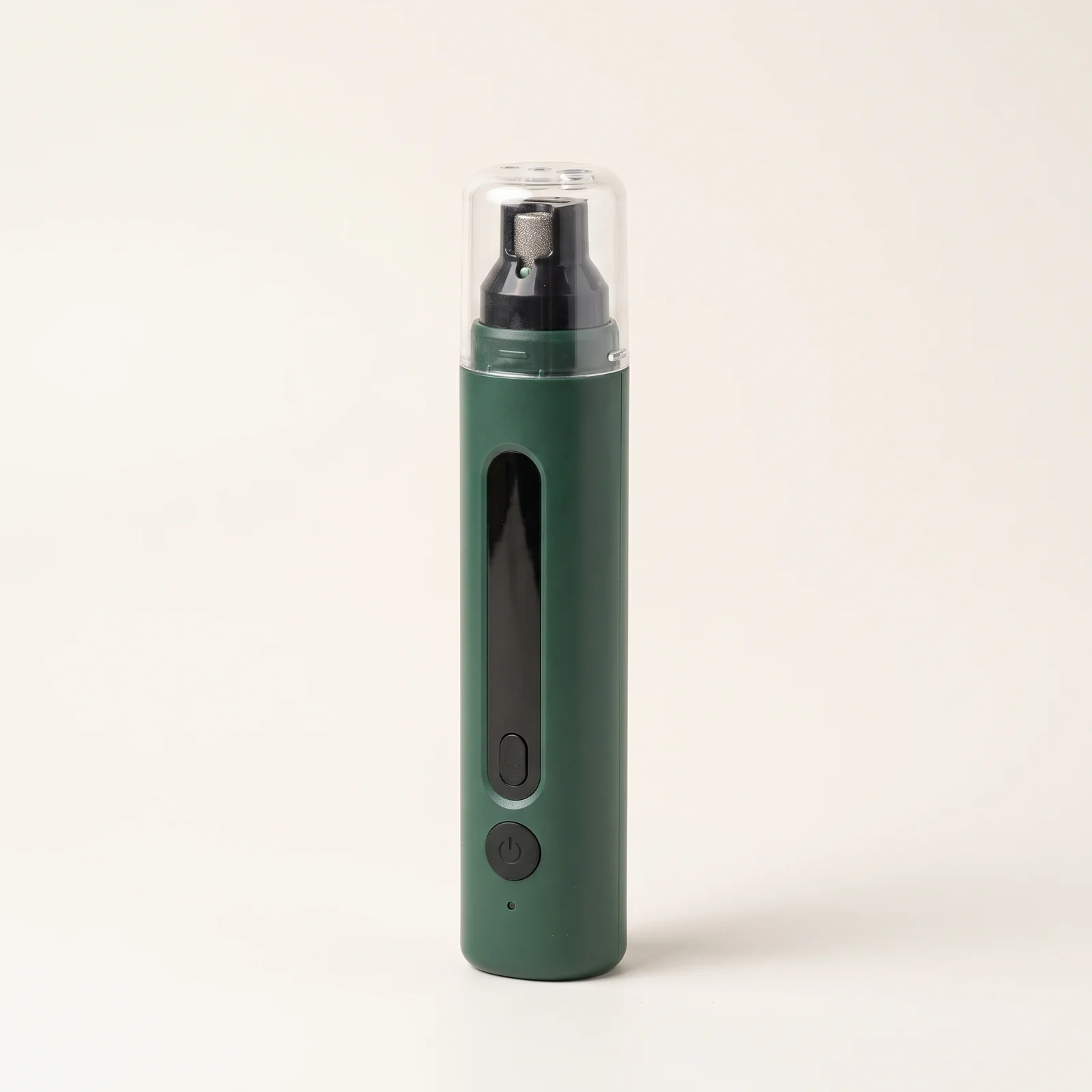 Sotto quiet nail grinder in deep green with its clear guard cap, standing upright on a warm off-white background